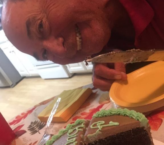 Dad cutting his cake